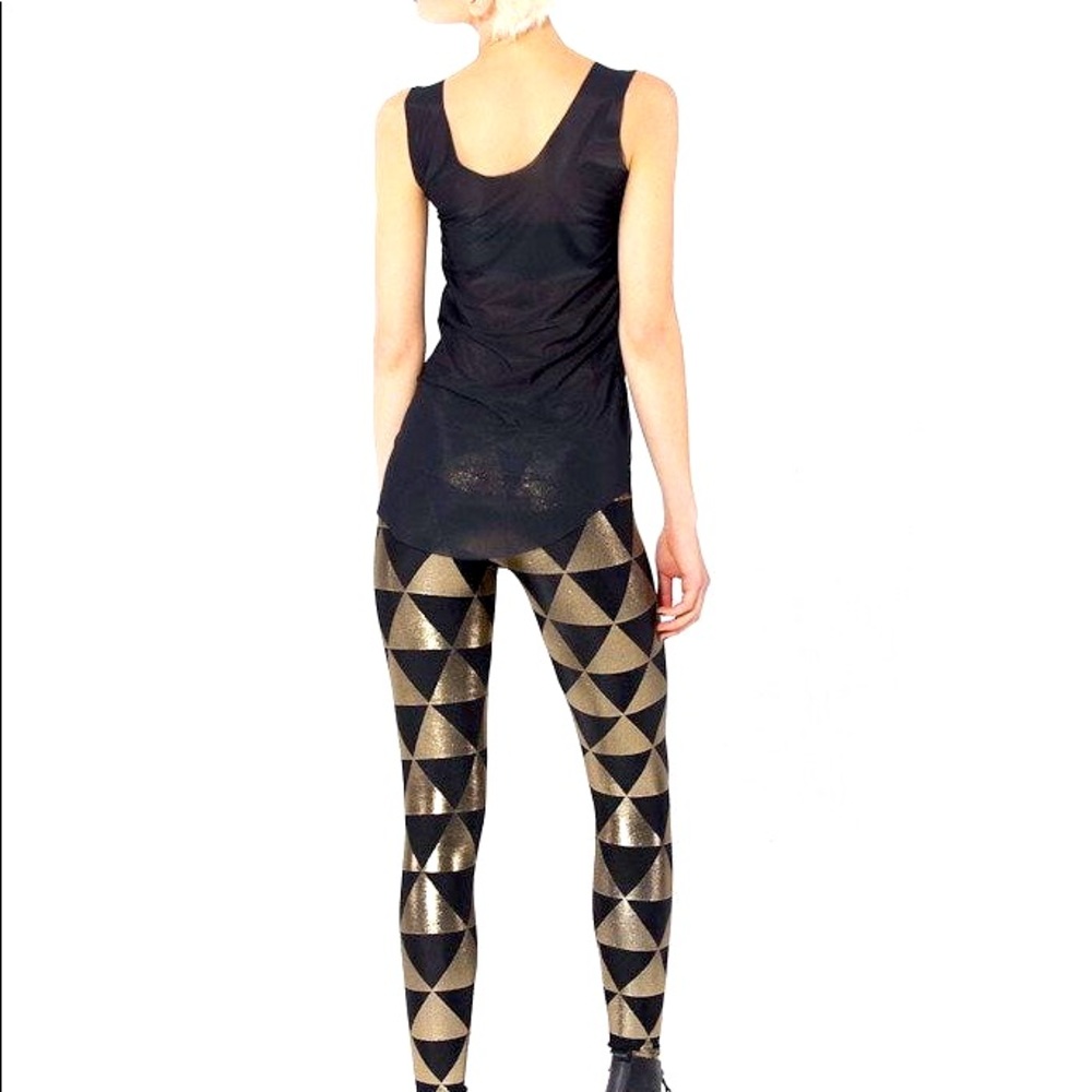 Black milk leggings with a gold and black triangle pattern.